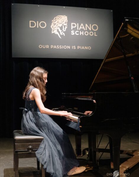 Girl Playing Grand Piano on Stage